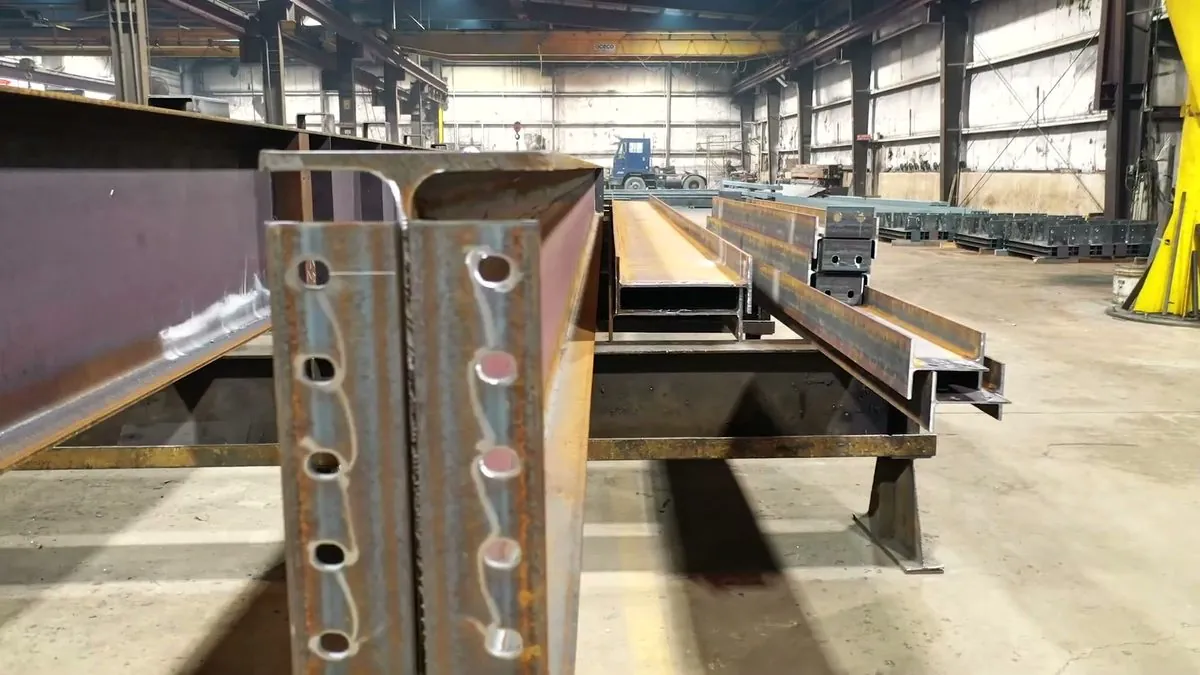 Processed wide-flange beams with punched connection holes on the shop floor