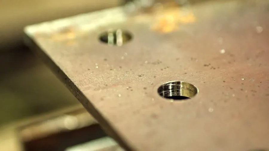 Close-up of clean drilled holes in a steel plate