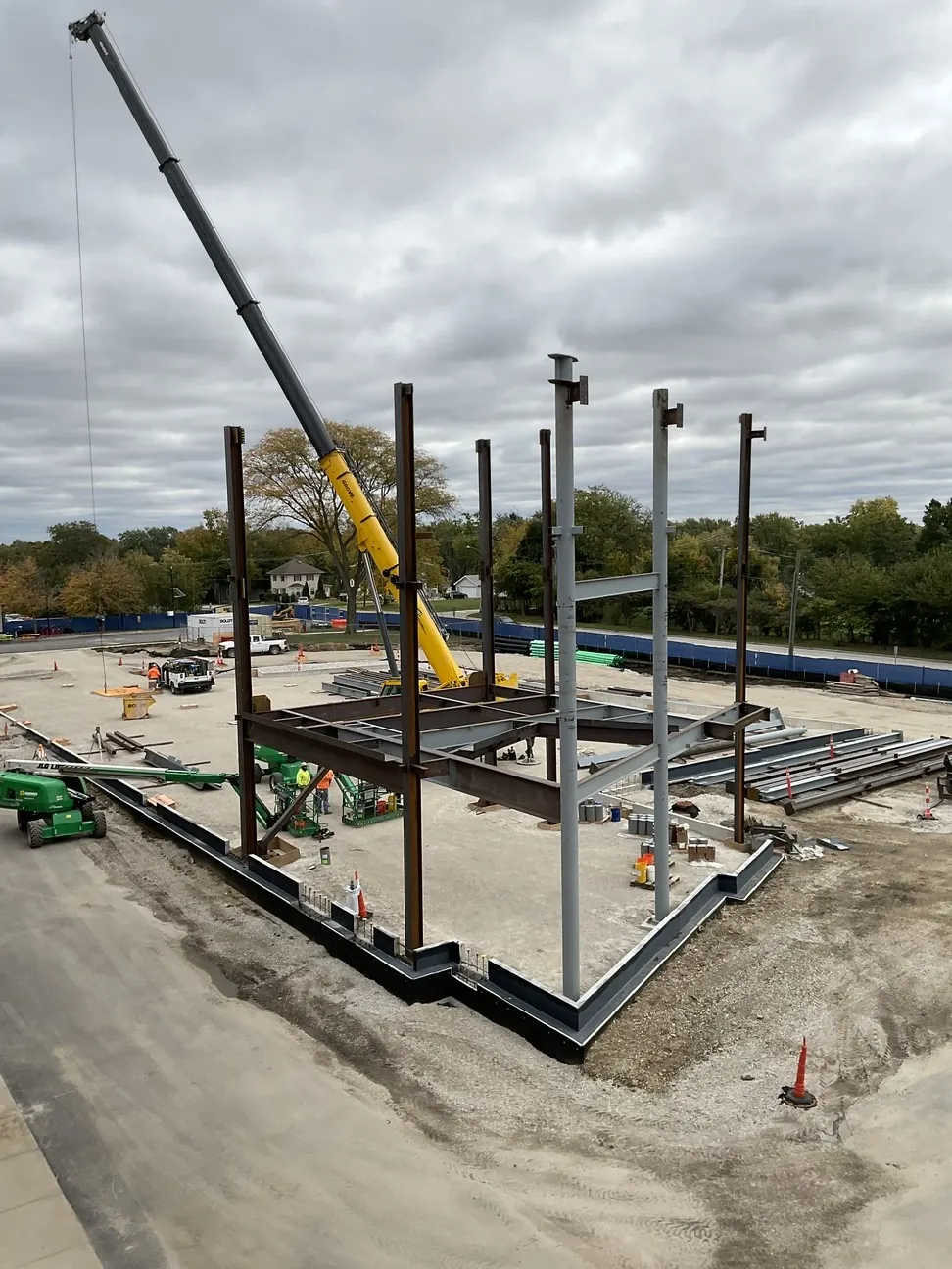 Aurora University Learning Commons: the first columns going up beside the crane on the foundation