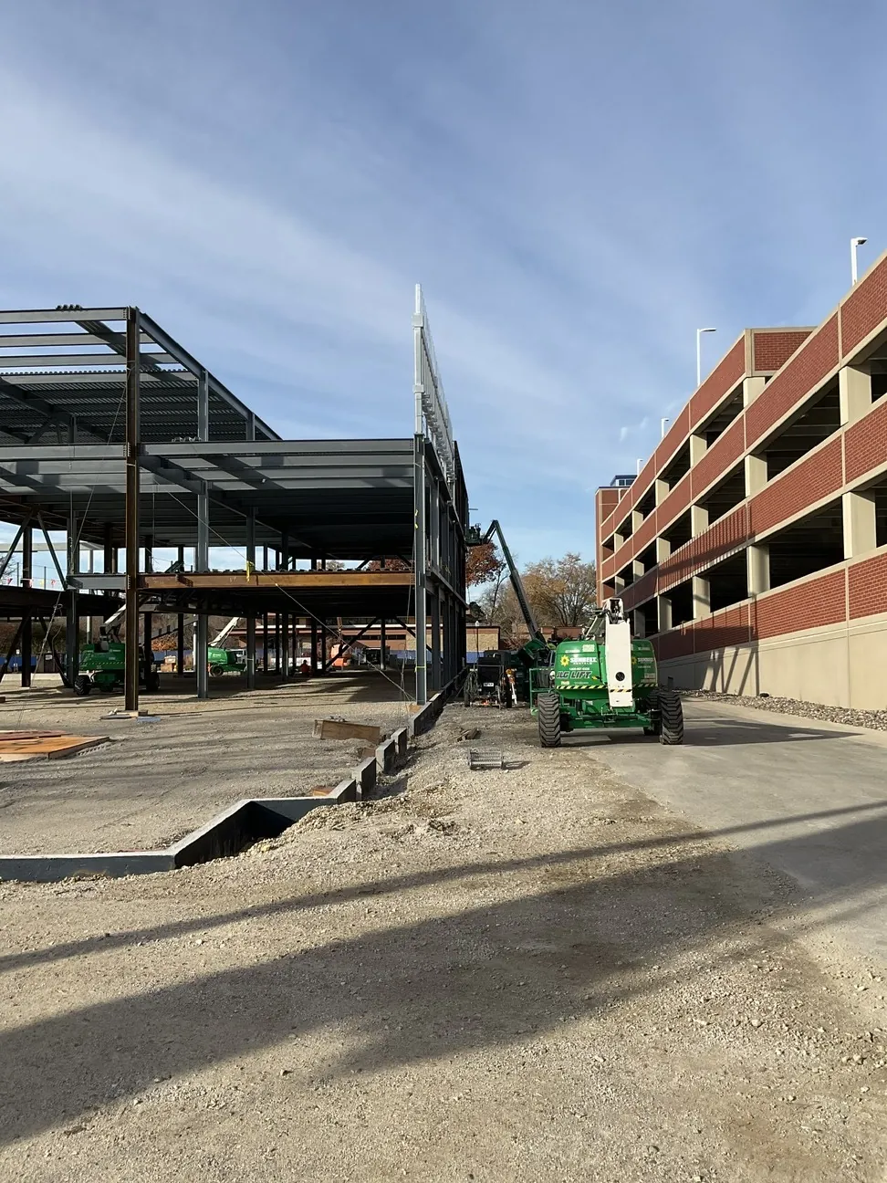 Aurora University Learning Commons: the frame beside the parking structure, with a lift in the drive