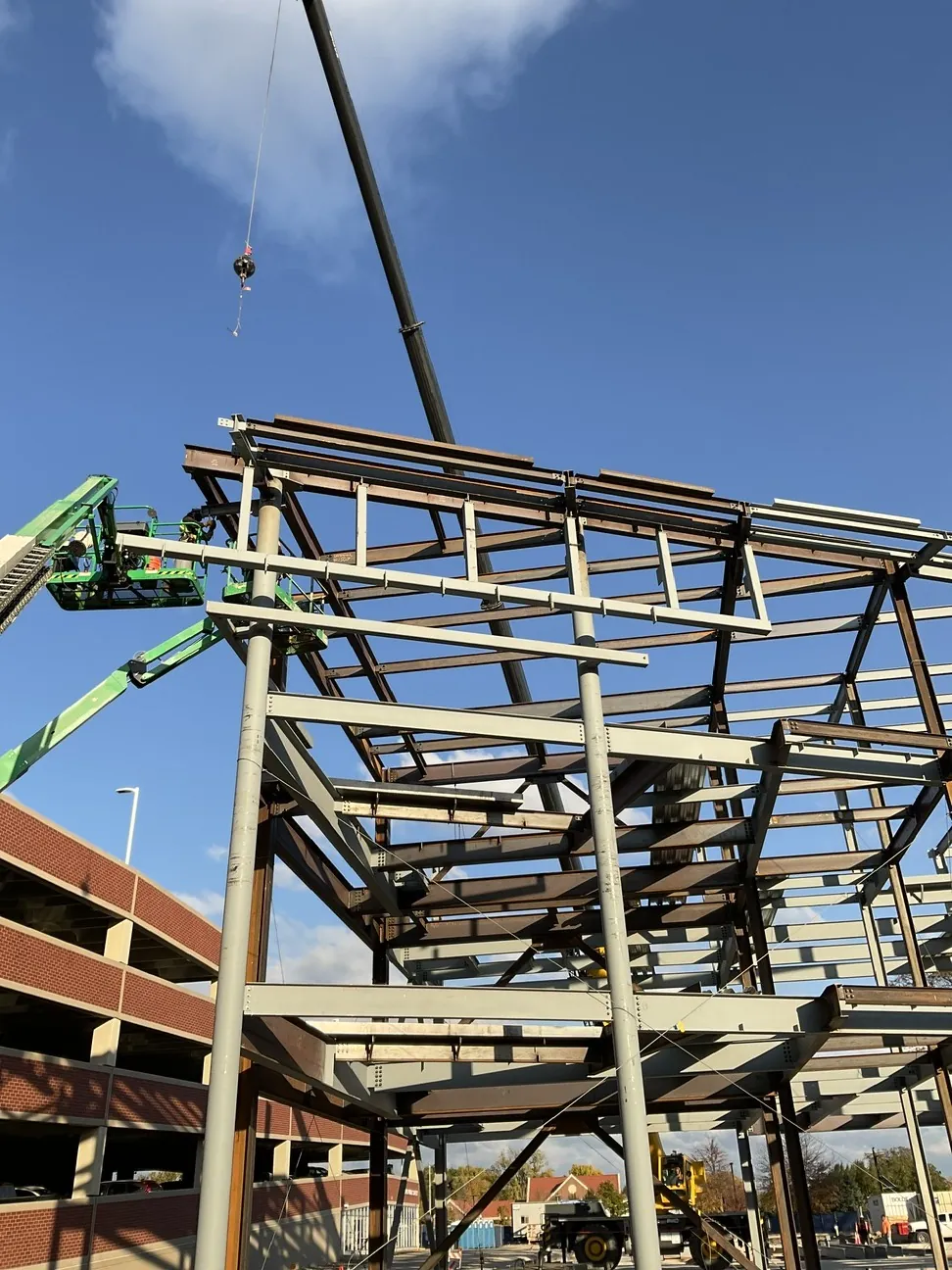 Aurora University Learning Commons: a cantilevered corner frame going up, with an ironworker on a lift