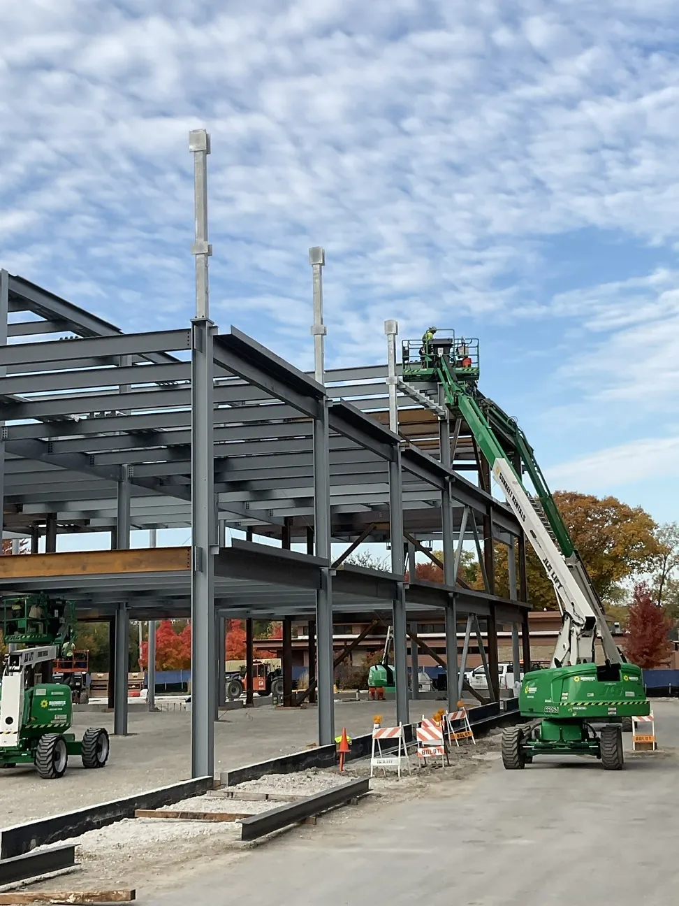 Aurora University Learning Commons: the three-level frame with an ironworker on a lift at the top