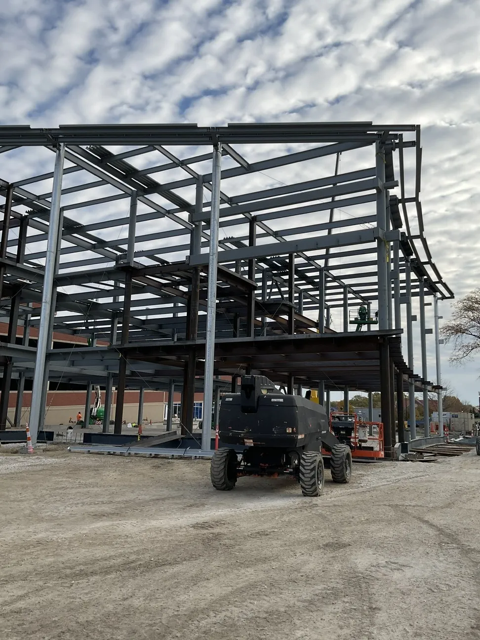 Aurora University Learning Commons: the frame with its upper floor beams, and a boom lift in front