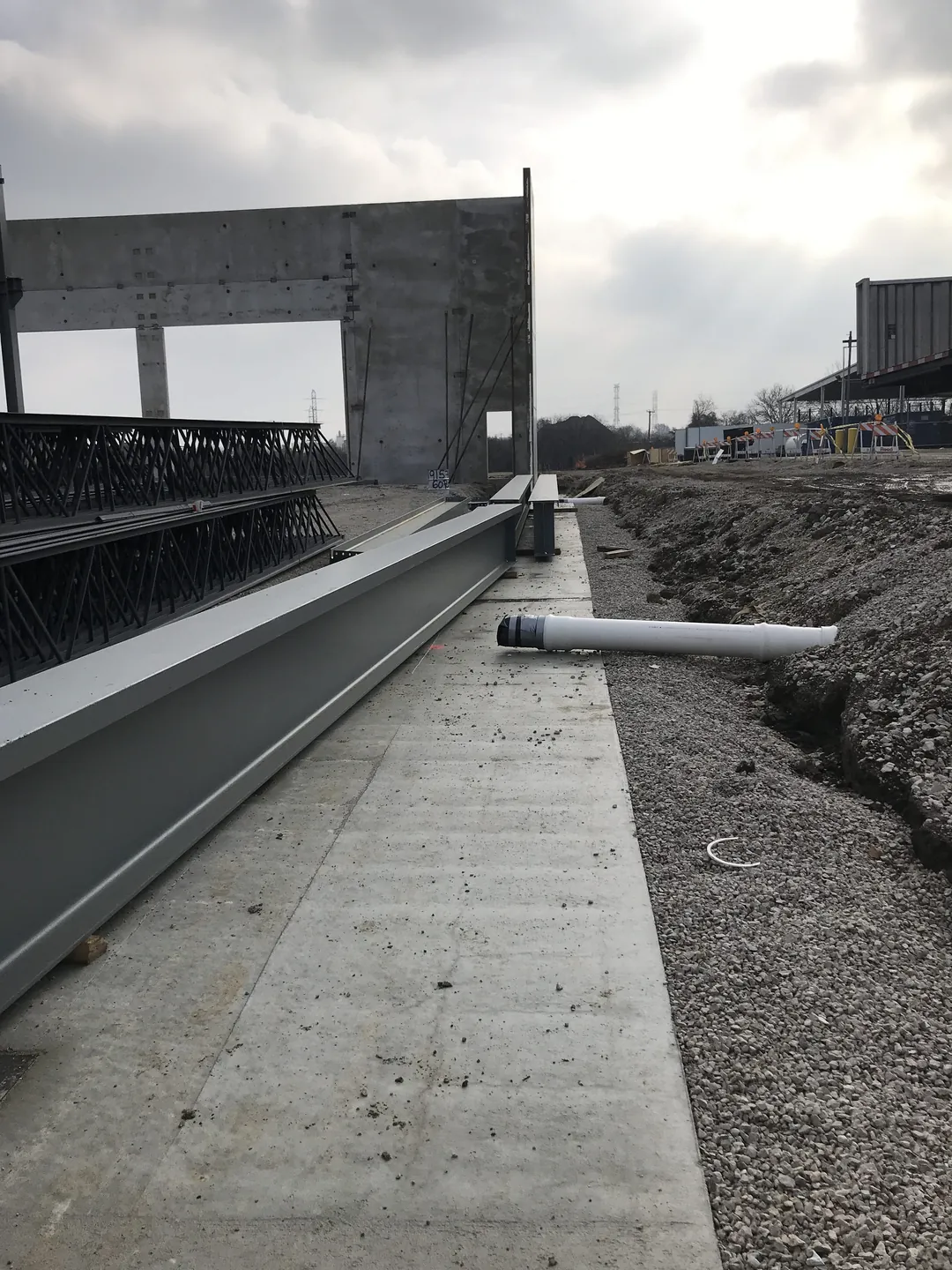 Bulldog Cartage: a steel beam laid along the footing beside the tilt-up wall panels