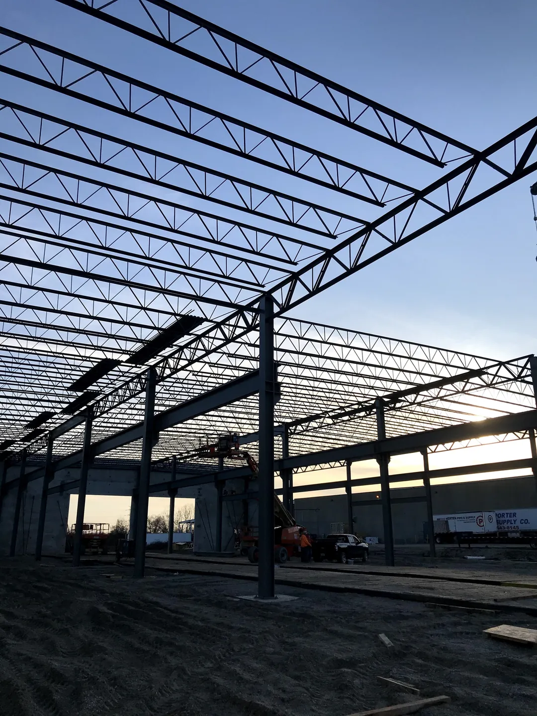 Bulldog Cartage: columns and joist girders under the roof joists at dusk