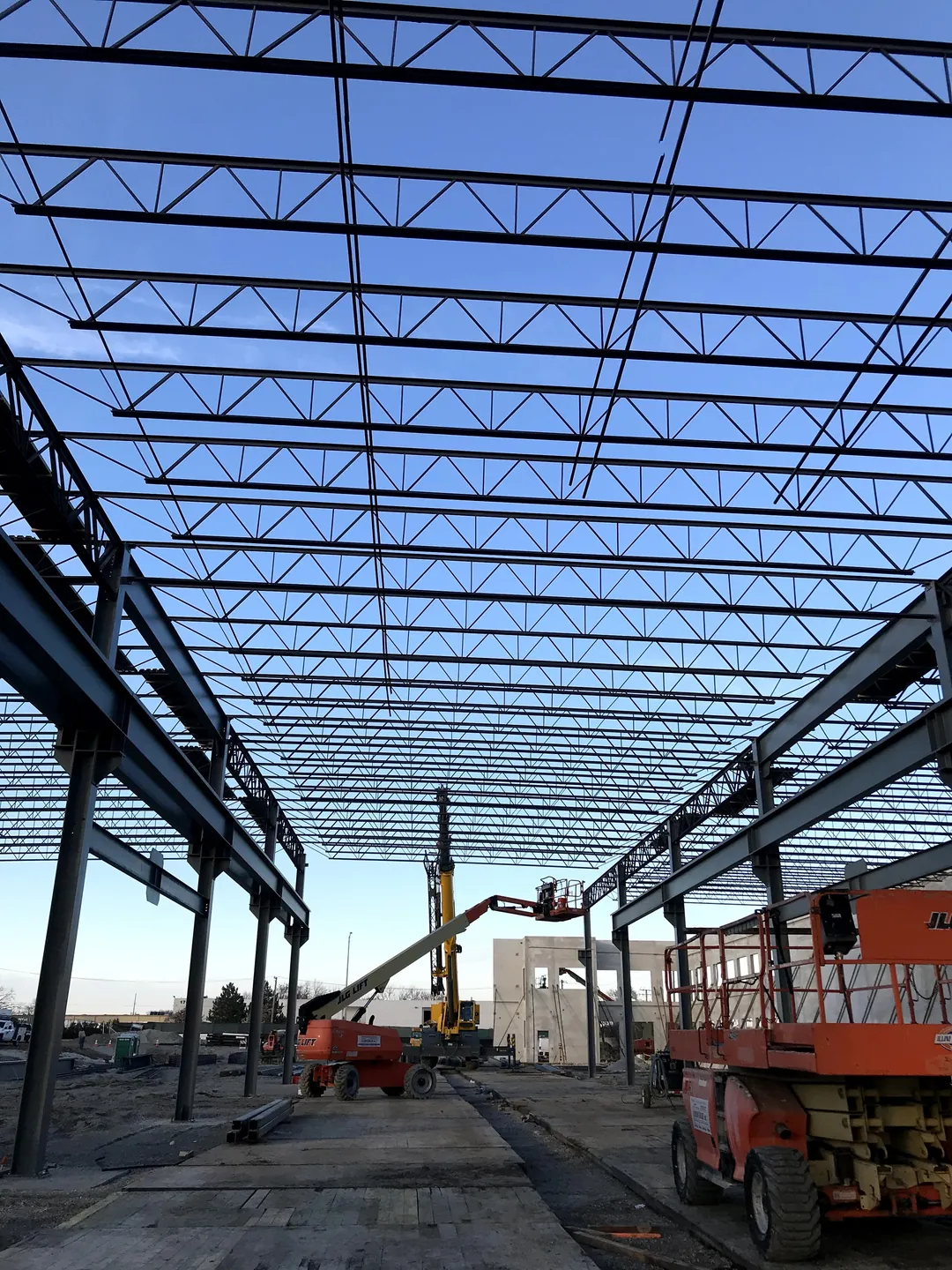 Bulldog Cartage: looking down a column line under the joist roof, with lifts at work