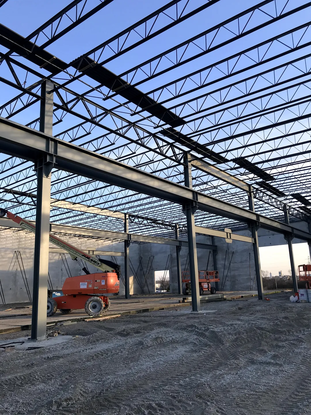 Bulldog Cartage: joist girders on interior columns, with a boom lift at the far wall
