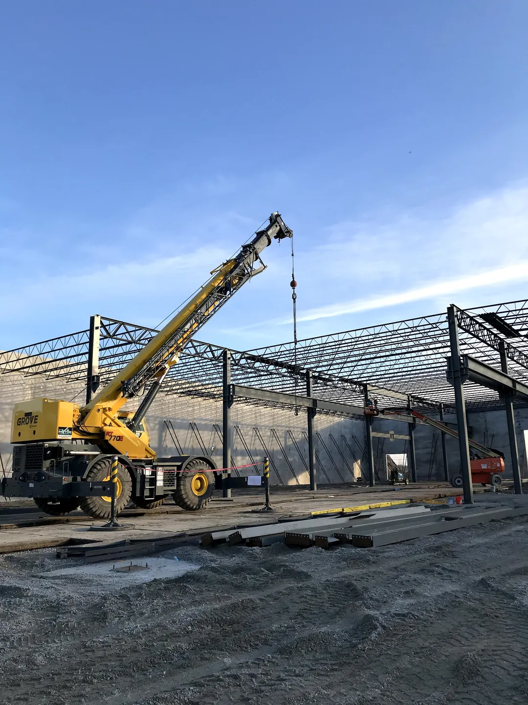 Bulldog Cartage: a rough-terrain crane beside the roof framing