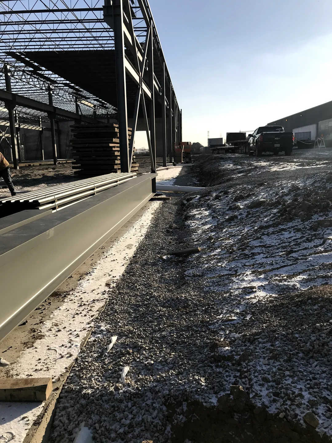 Bulldog Cartage: steel staged along the footing beside the building