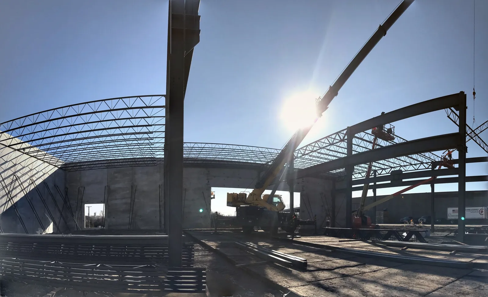 Bulldog Cartage: roof joists set over the tilt-up walls, with a crane and lifts at work
