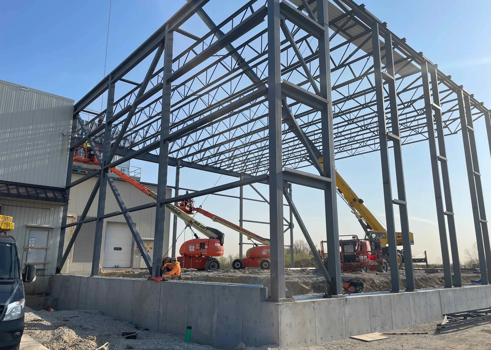 DOT Foods: columns, girts and roof joists rising beside an existing building