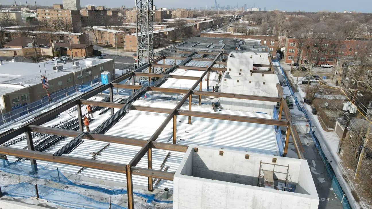 Project HOOD: steel framing across the decked level, with the tower crane behind