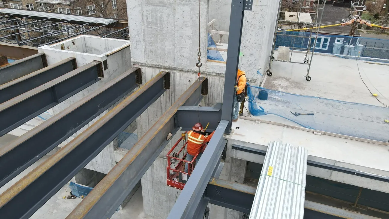 Project HOOD: ironworkers setting beams against the concrete core