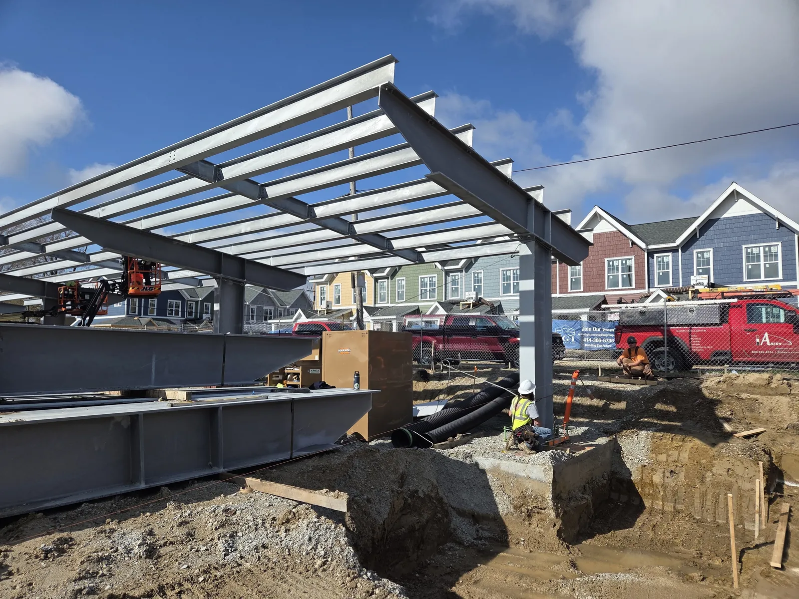 Lincoln King Center: galvanized canopy beams on a cantilevered column, with steel staged below
