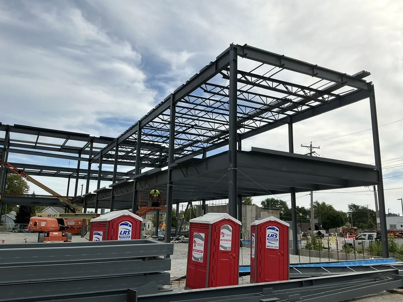 Lincoln King Center: roof joists and beams over the decked floor, with steel staged in the foreground