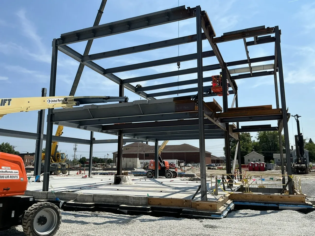 Lincoln King Center: the upper floor framing, with ironworkers on lifts and a crane at work