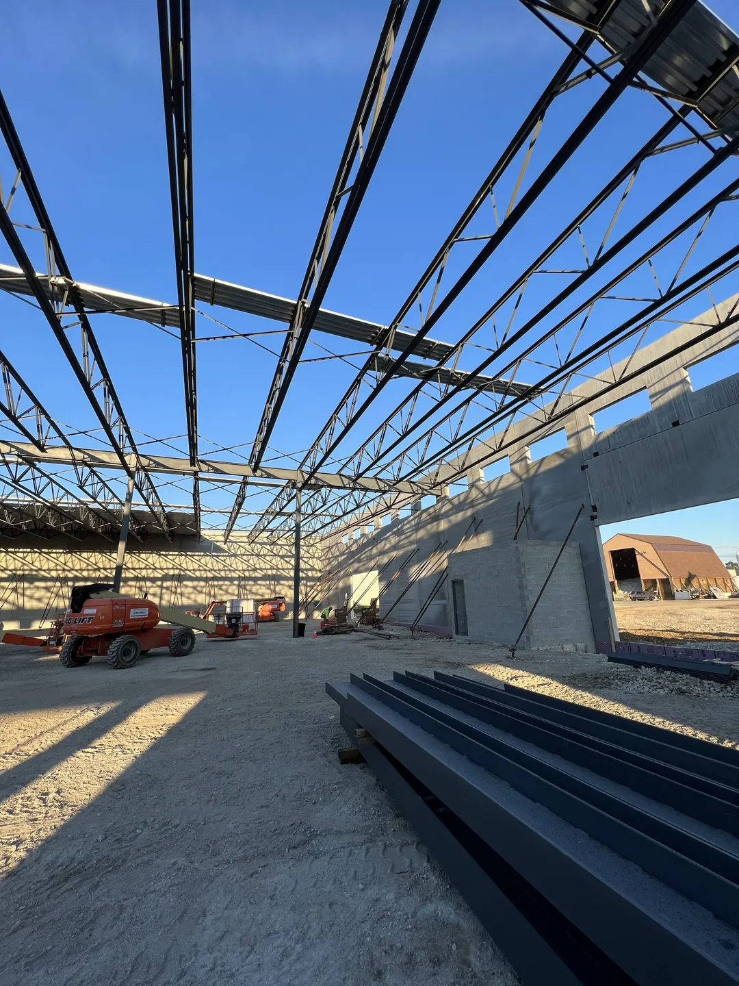 Montgomery Public Works: roof joists over the open floor, with steel staged in the foreground