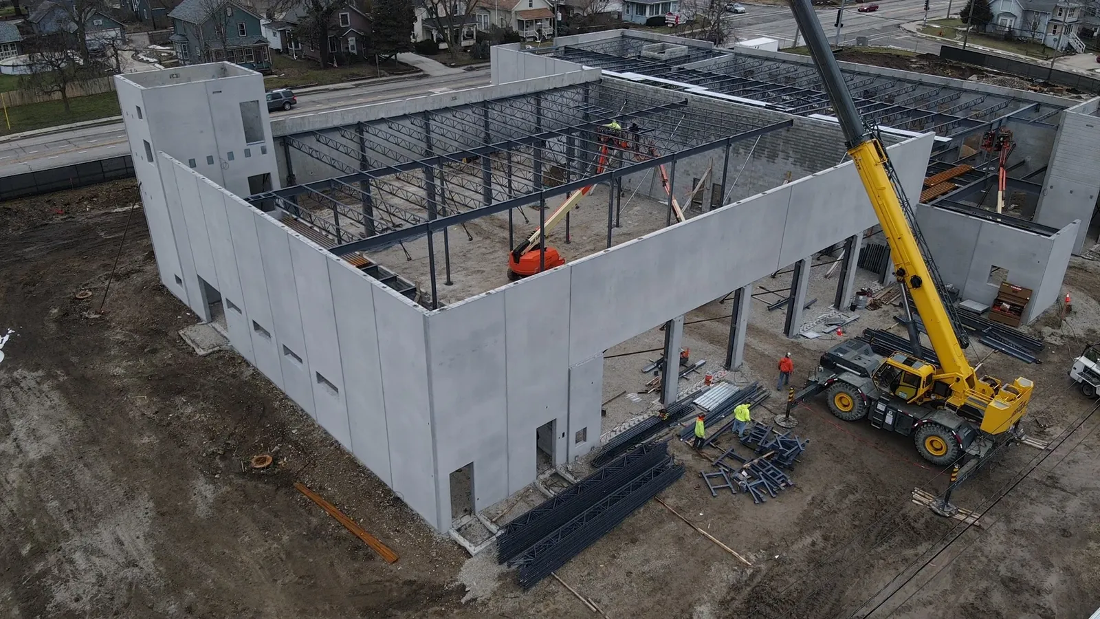 North Aurora Fire District Headquarters: aerial view of the crane beside the building, with roof joists going in