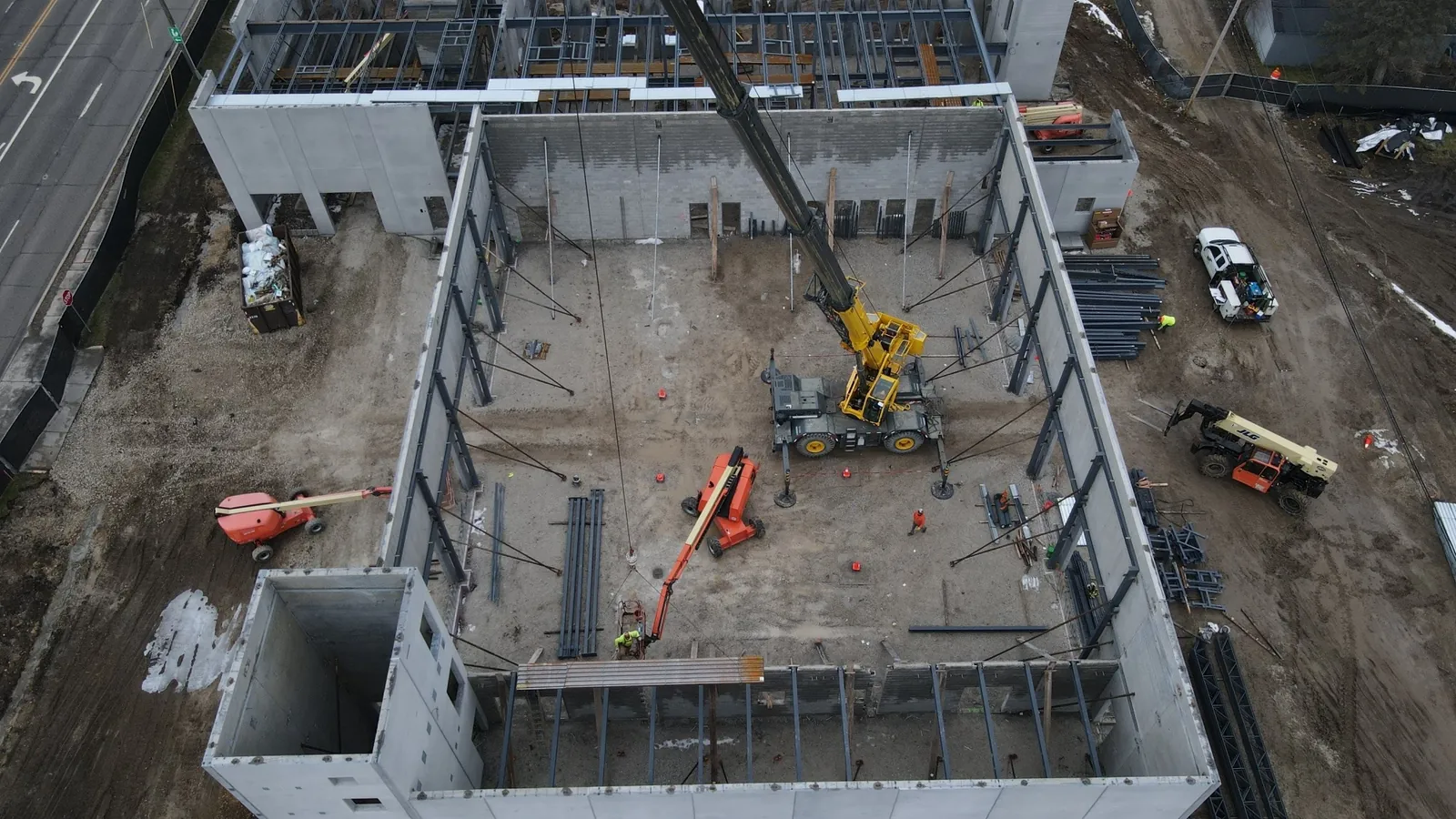 North Aurora Fire District Headquarters: aerial view into the precast building, with a crane setting steel