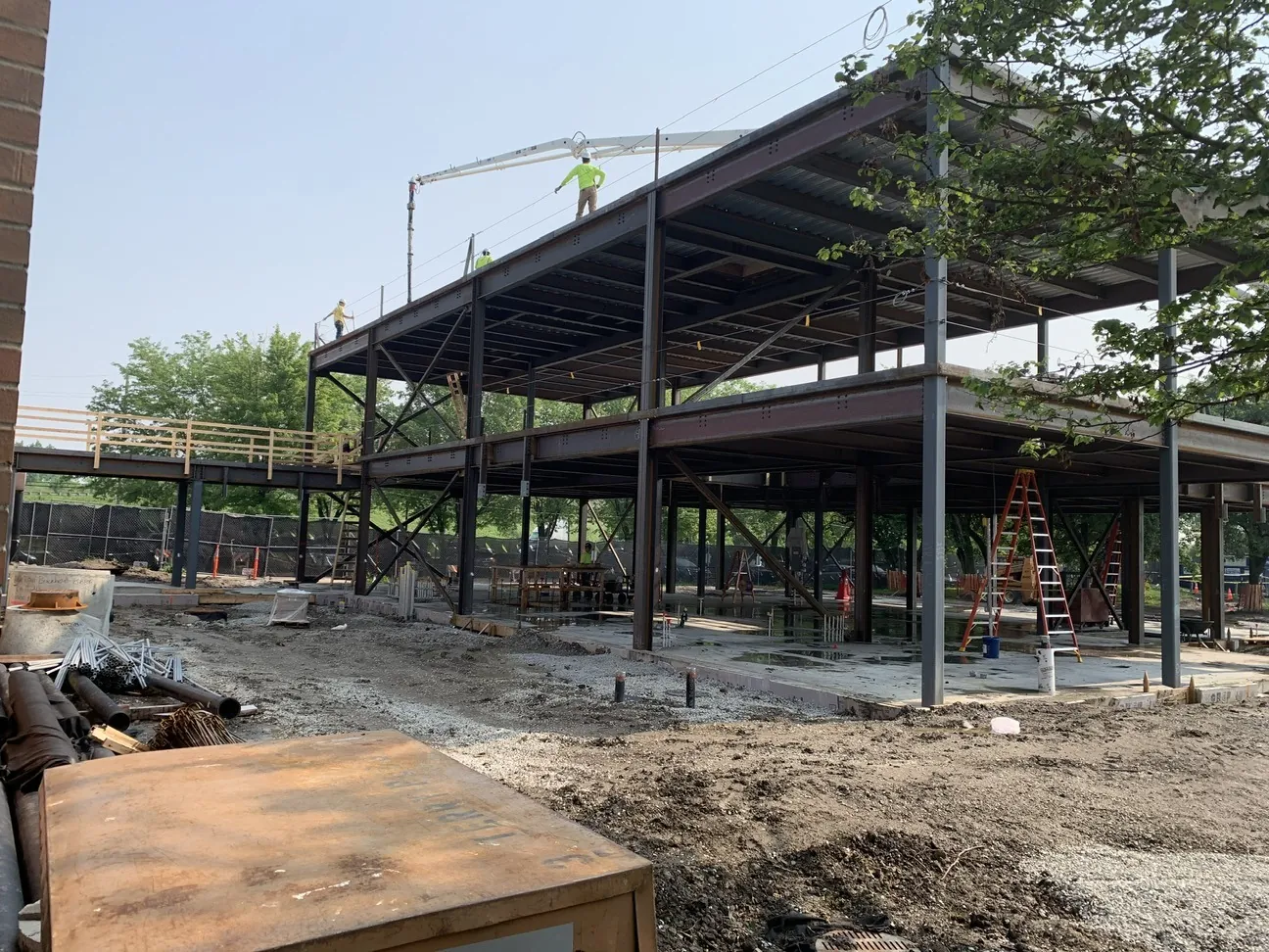 TCA Health: floor and roof framing on the addition, with an ironworker on the roof beams
