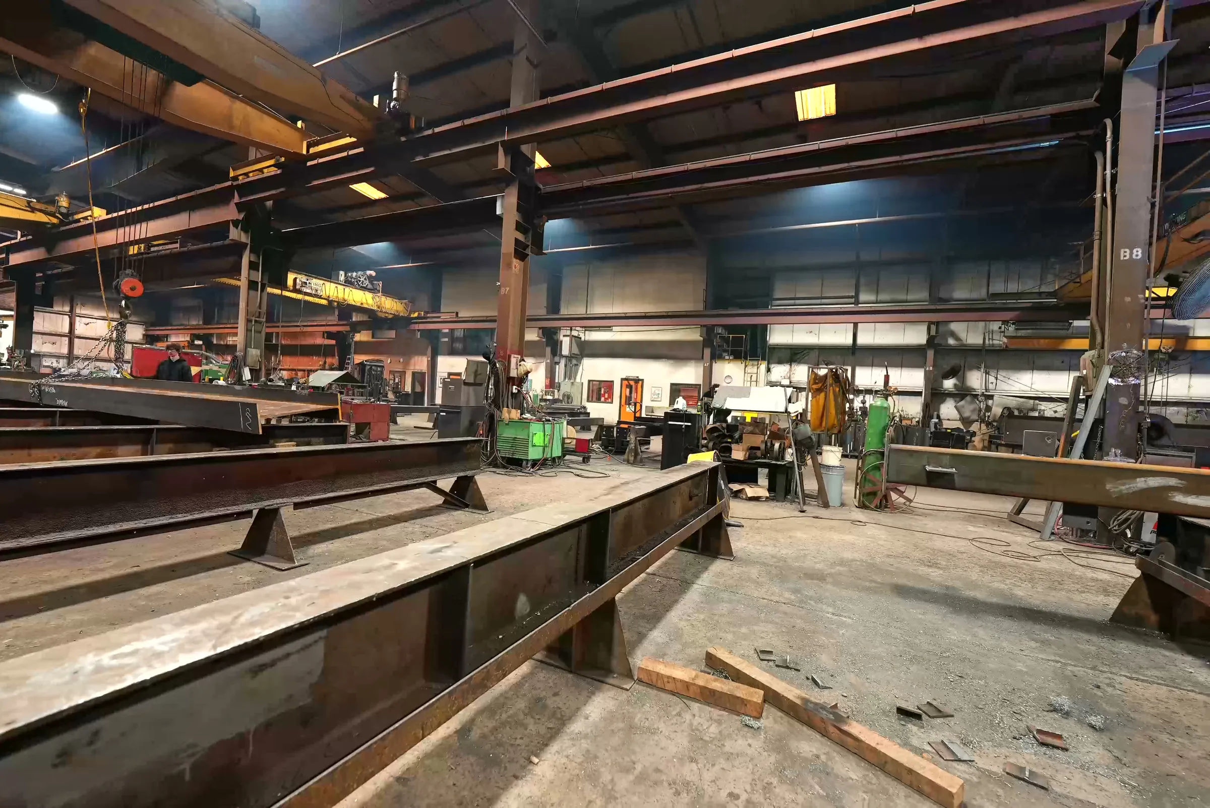 Main fabrication bay with beams staged on the floor