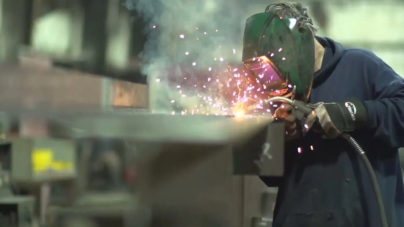 A Garbe Iron Works welder joining a steel member in the shop